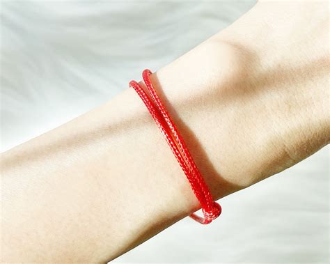 red wrist band tucker bracelet.